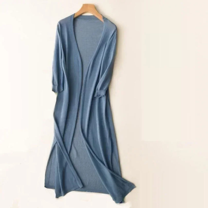 Model walking in a women's long open front cardigan, showing fluid movement & comfort.