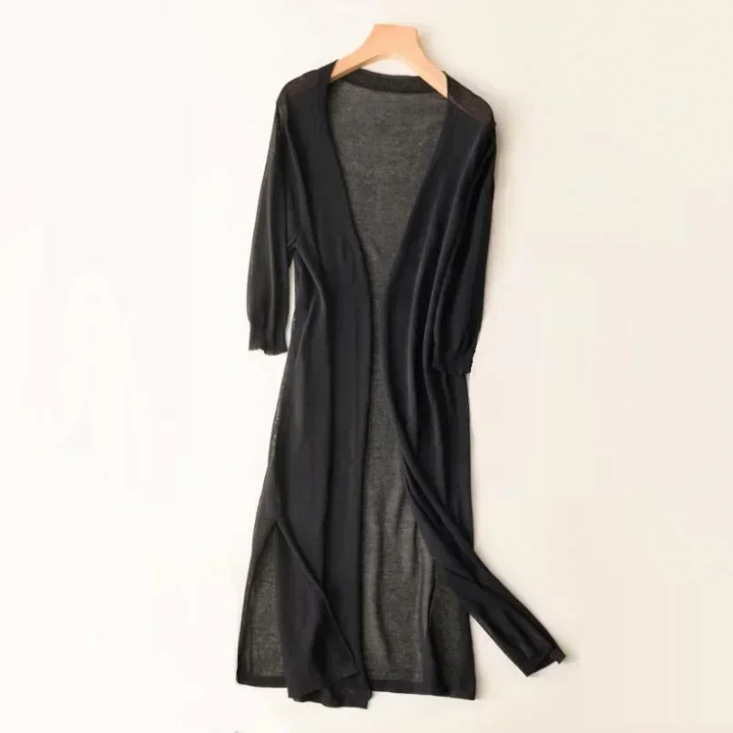 Women's long open front cardigan, styled casually with jeans for a comfortable, chic look.