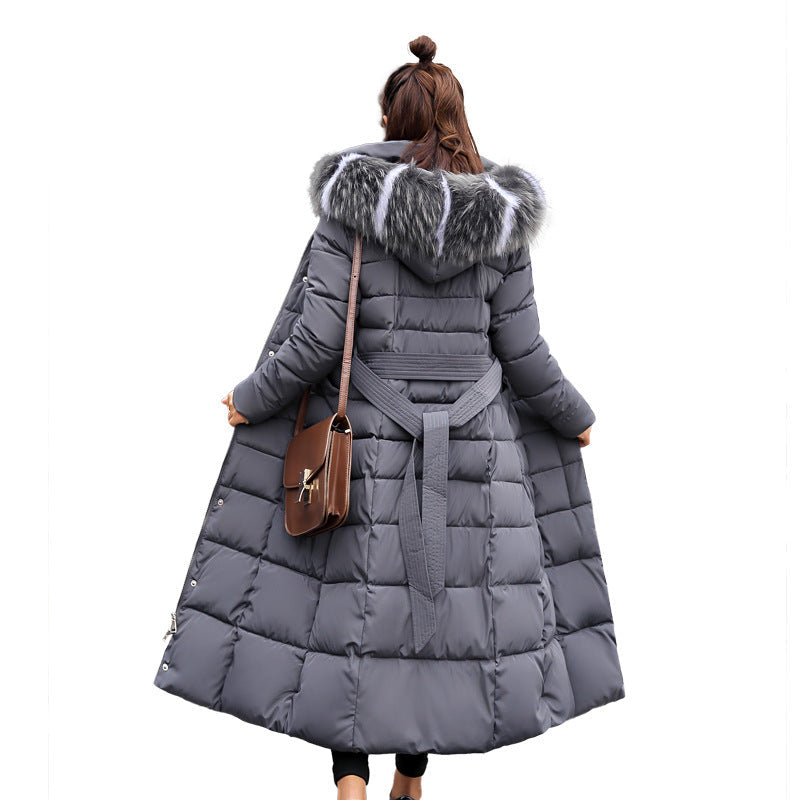 Fashionable women's long quilted parka, with a protective hood & elegant belt. Essential outerwear.