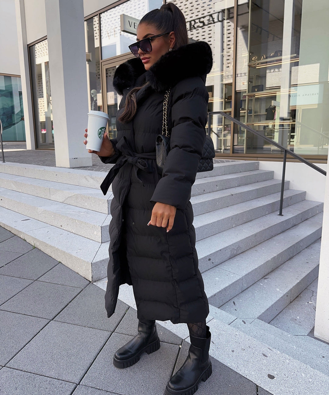 Back view of the stylish ladies' long parka, showcasing its quilted design & comfortable fit.