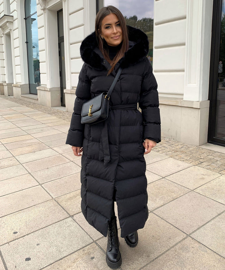 Close-up of the plush hood on a warm women's long quilted winter parka, great for cold weather.