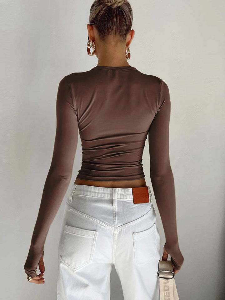 Detail shot of a women's round neck long sleeve crop top fabric, emphasizing comfort and style