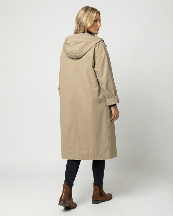 All-weather women's waterproof trench coat. Long, windproof jacket for chic protection, classic style & elegant fashion.
