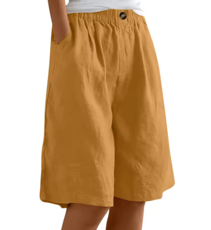 Stack of women's high-waisted wide-leg shorts with elastic waists, emphasizing product variety.