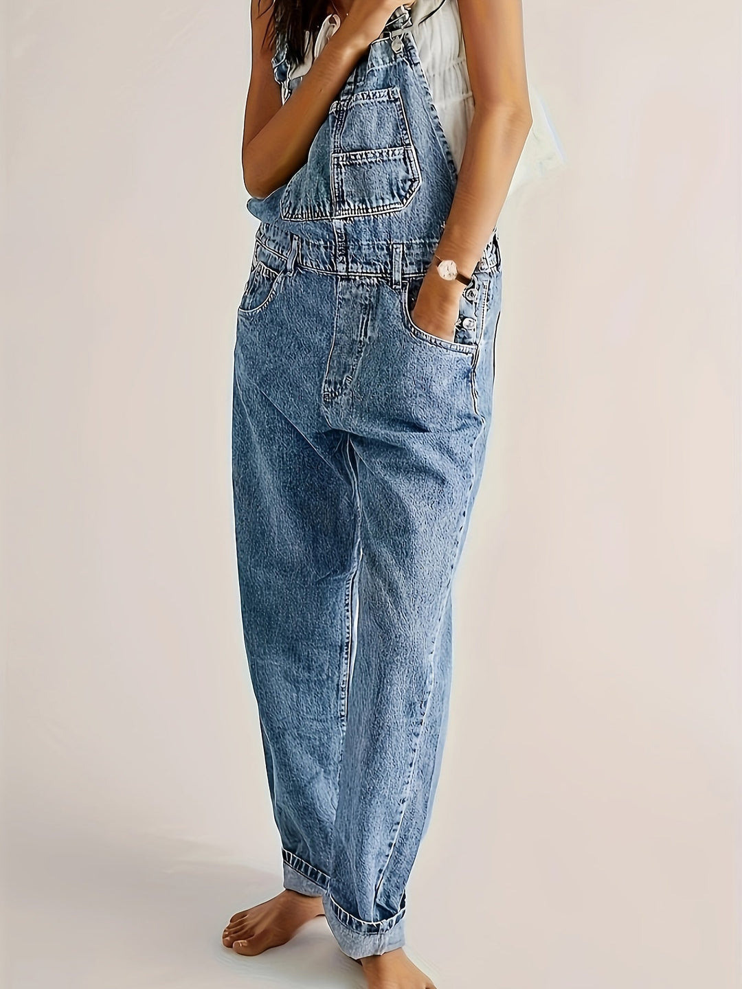 Woman casually walking in comfortable loose fit denim dungarees, perfect for everyday outfits.