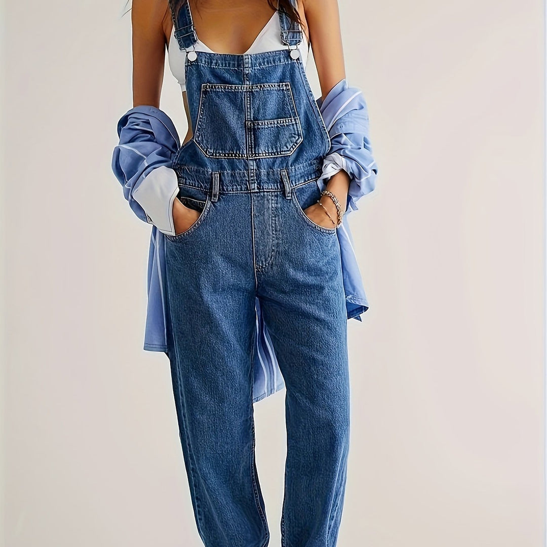 Relaxed woman sitting in her versatile loose fit denim overalls, ideal for casual comfort.