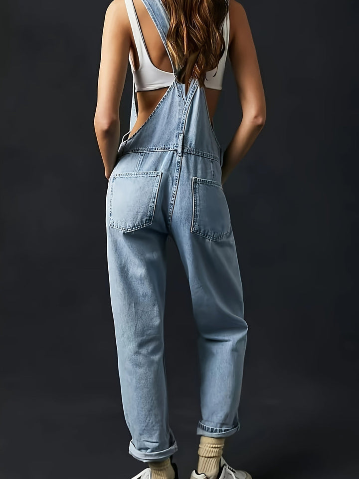 Detailed texture of soft denim fabric on women's loose fit dungarees, comfy casual wear.