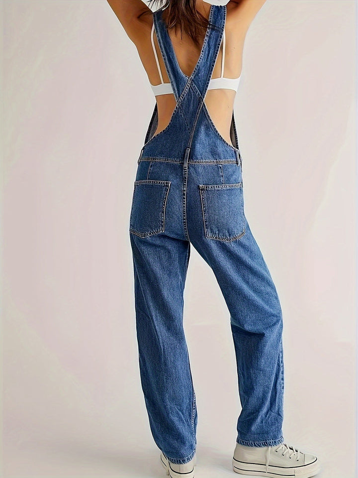Functional pockets on casual loose fit denim dungarees, practical ladies apparel for everyday.