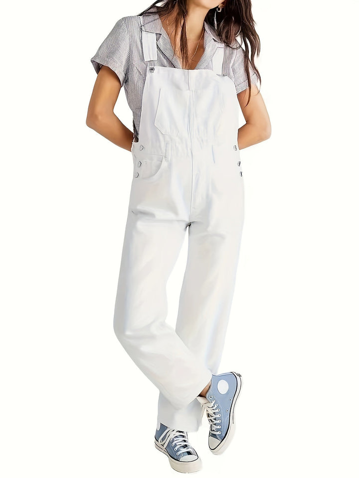 Layered look: loose fit denim dungarees worn over a cozy sweater for cool weather casual style.