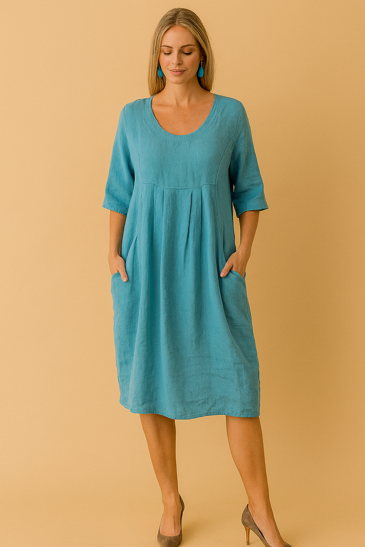 Women's loose summer dress with round neck, short sleeves & pockets. Comfortable knee-length casual swing dress.