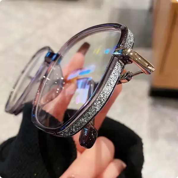 Woman wearing luxurious reading glasses, demonstrating comfortable fit & timeless style as a vision aid.