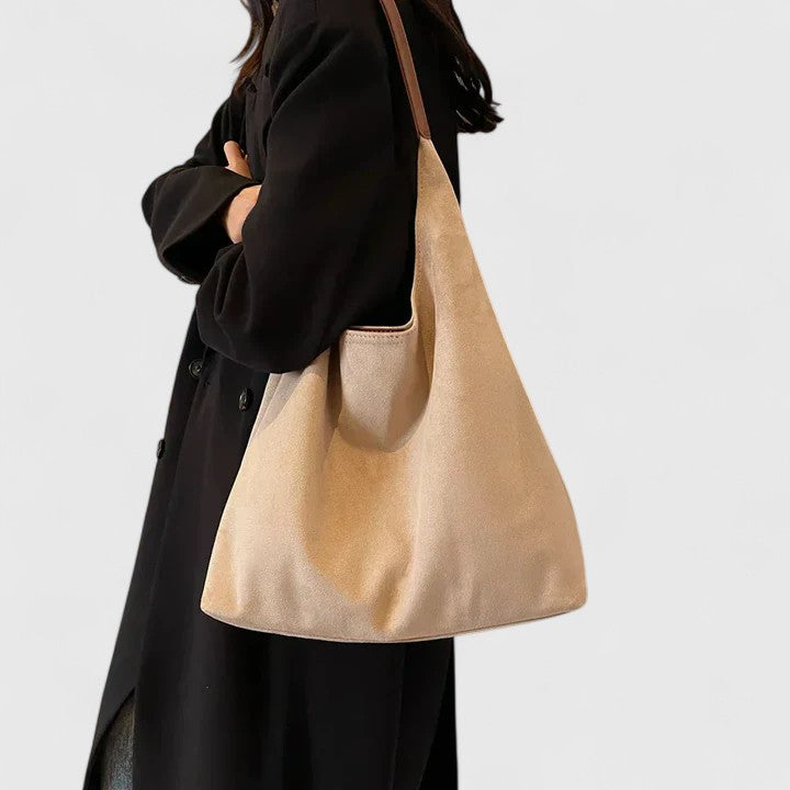 Casual women's handbag: a sleek, minimalist design in a neutral tone.