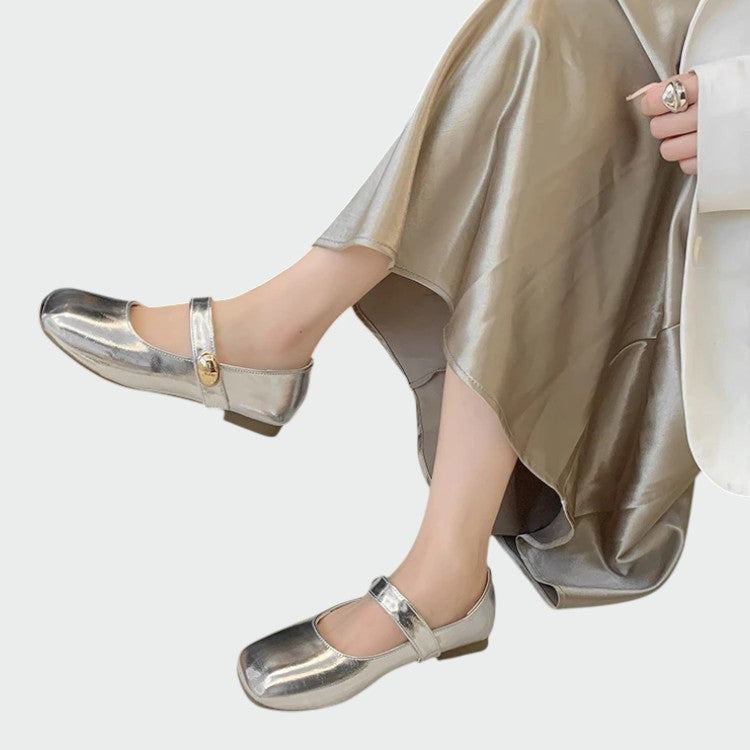 Women's minimalist glossy black Mary Jane flats with square toe and buckle strap, elegant comfort shoes.