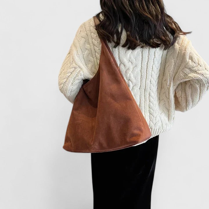 Women's minimalist shoulder bag in beige, perfect for everyday carry and a versatile fashion accessory.