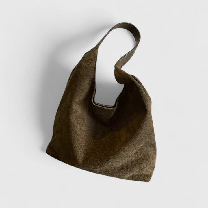 Side view of a women's minimalist shoulder bag, showcasing its sleek design for everyday use.