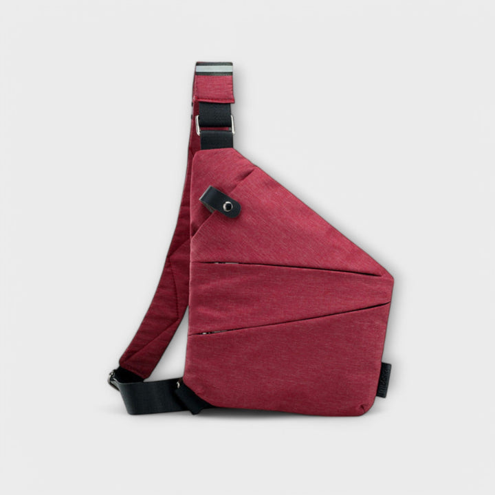 Women's fashion bag, crossbody utility style, resting on a wooden bench outdoors
