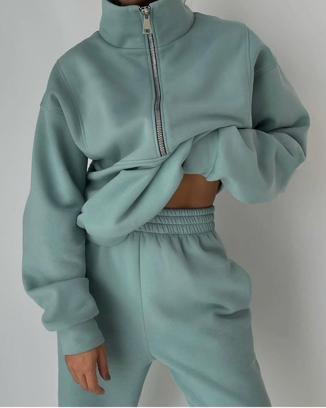 Women's modern half-zip sweatshirt and jogger set in soft loungewear fabric, ideal for casual comfort.