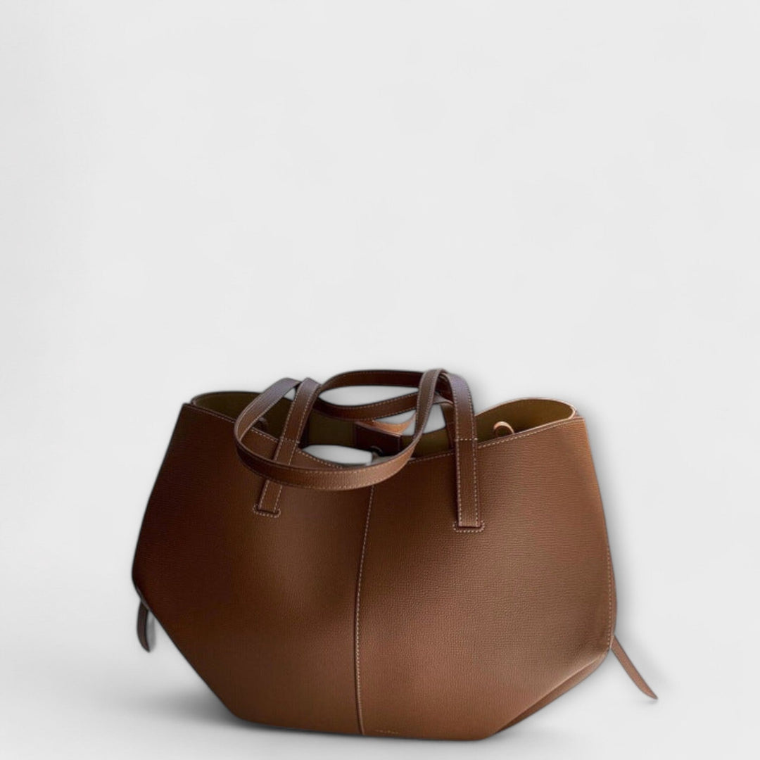 Women's modern tan leather everyday handbag with spacious design and shoulder strap