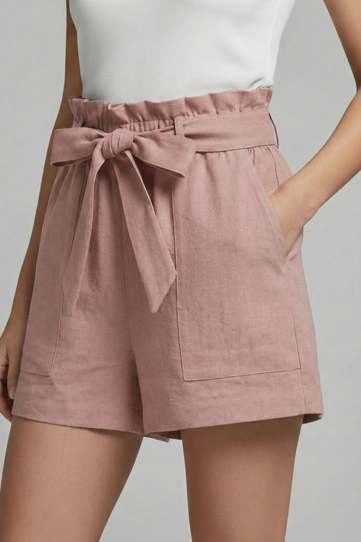 Model wearing women's high-waisted tie waist summer shorts with pockets, styled casually.