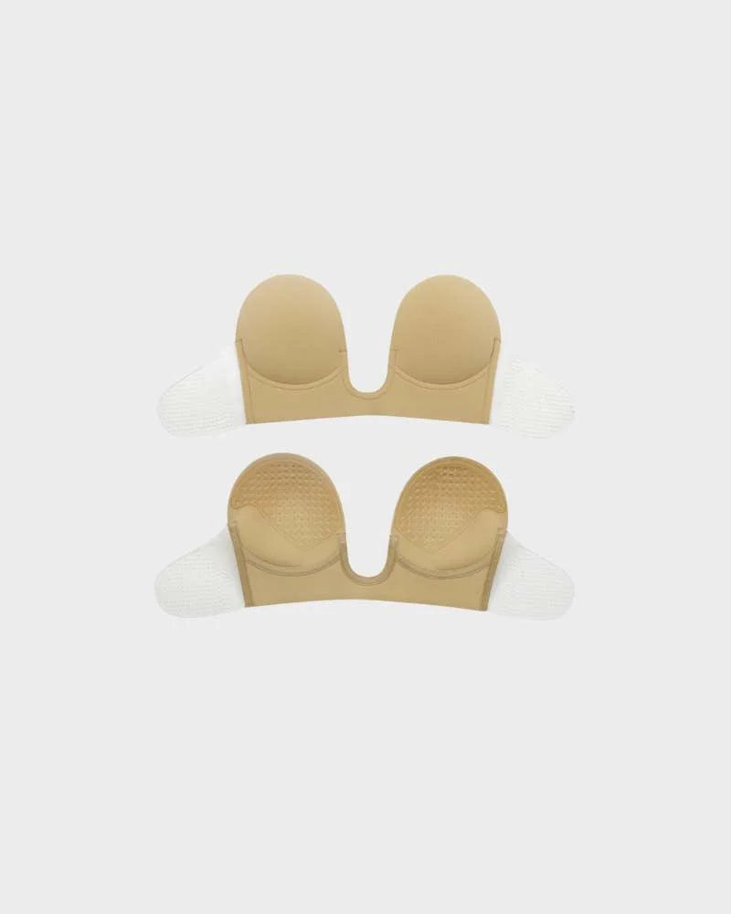Women's strapless deep-U push-up bra in beige. Invisible backless adhesive lingerie for a smooth look.