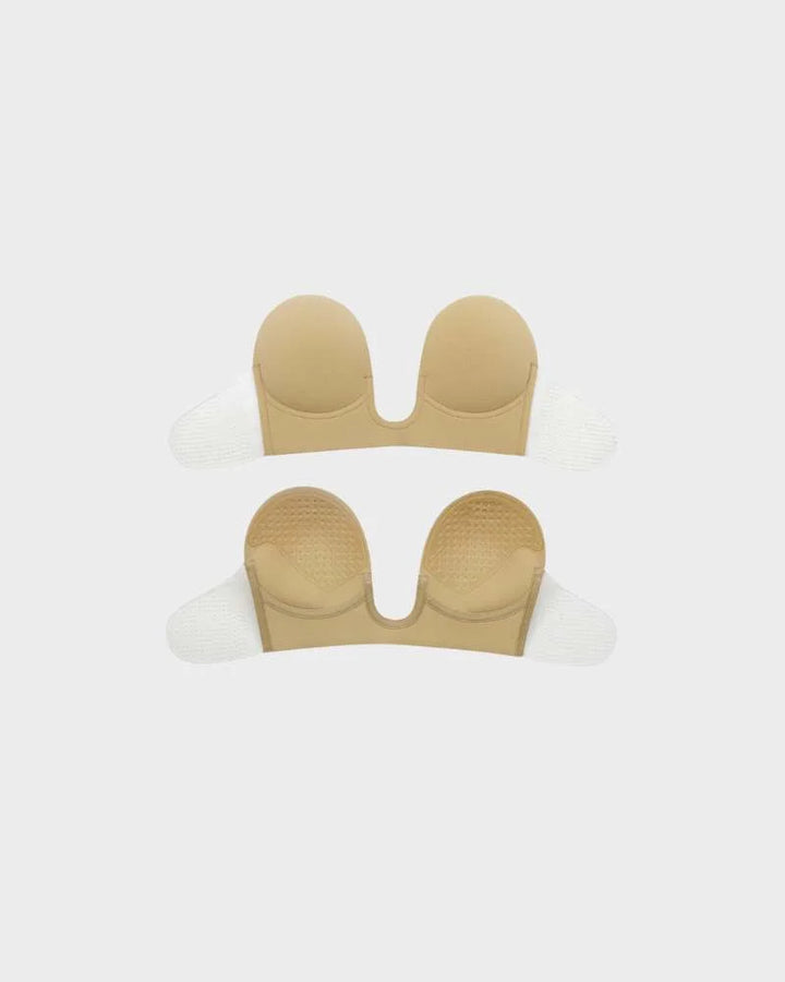 Women's strapless deep-U push-up bra in beige. Invisible backless adhesive lingerie for a smooth look.