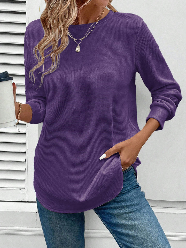 Detail of the cuff and hem of a women's O-neck long sleeve cotton blend top, quality casual wear.