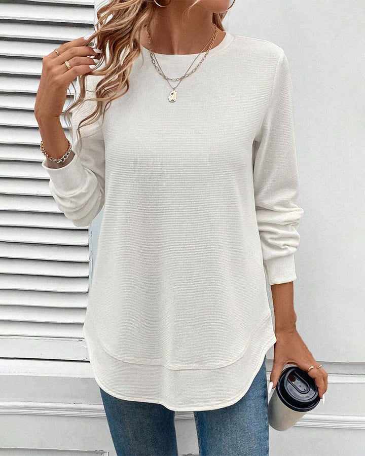 Close-up of the O-neck and cotton blend texture of a women's long sleeve top, everyday basic.