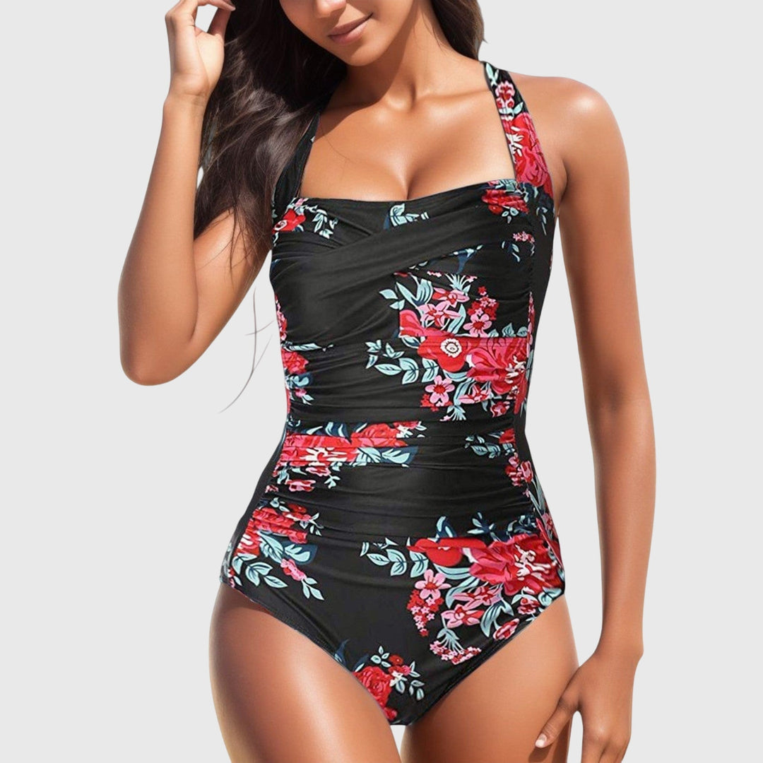 Elegant women's tropical print one-piece, perfect for beach holidays and resort fashion.