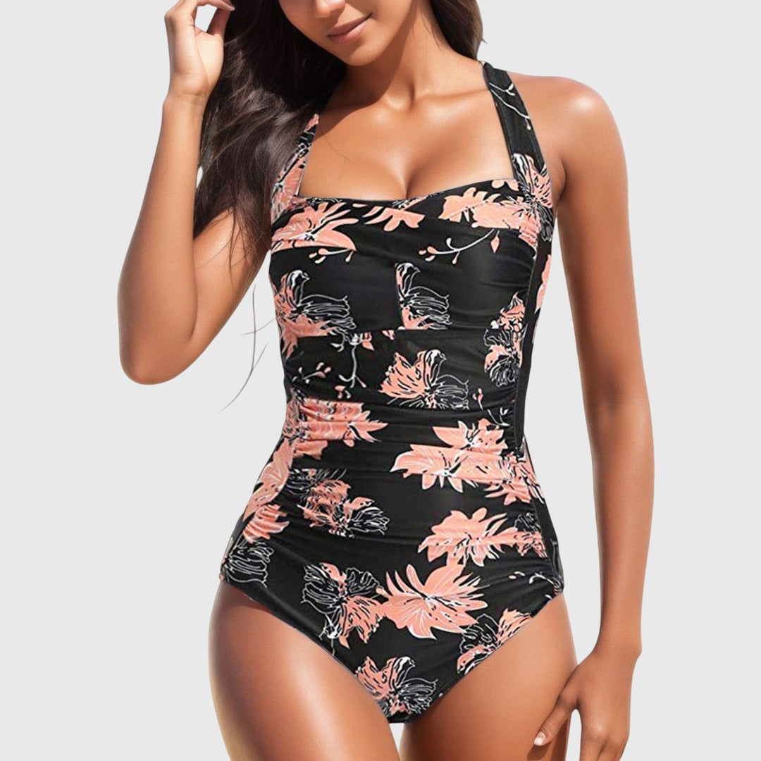 Women's summer fashion: a tropical print one-piece swimsuit, perfect for a day at the beach.
