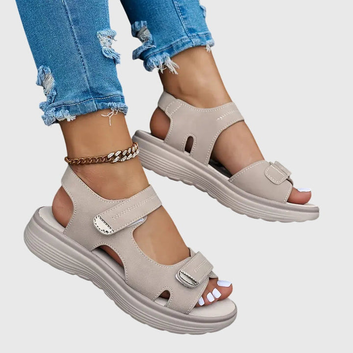 Women's comfortable orthopaedic sandals on feet, showing practical design for pain relief & support.