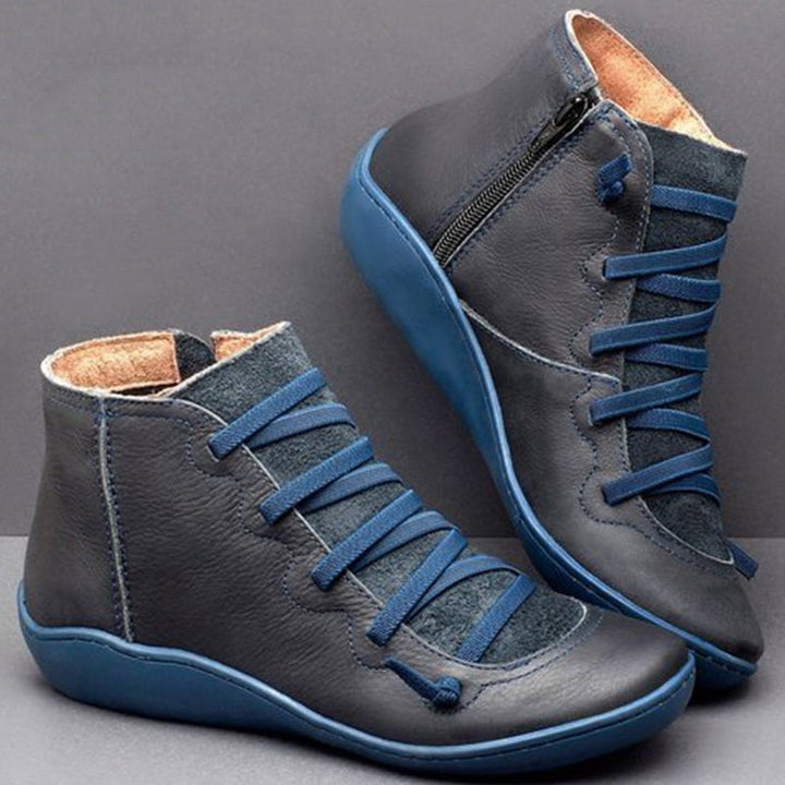ComfortStep Luxe women's PU leather ankle boots. Orthopedic design with a practical zip and flat heel for comfort.