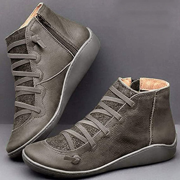 Supportive women's orthopedic ankle boots. Designed with arch and posture support for comfort, featuring a side zip.