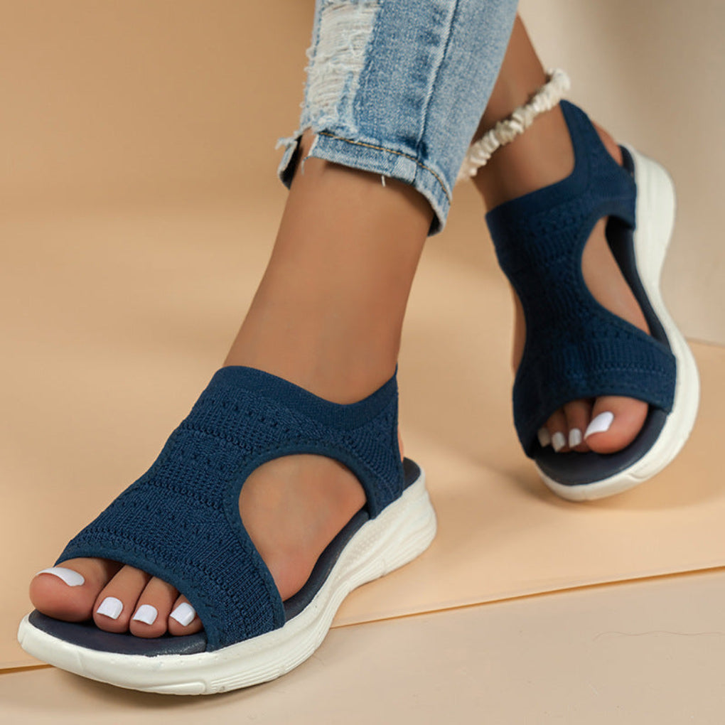 Pair of women's slip-on orthopedic summer sandals with soft knit upper and athletic sole