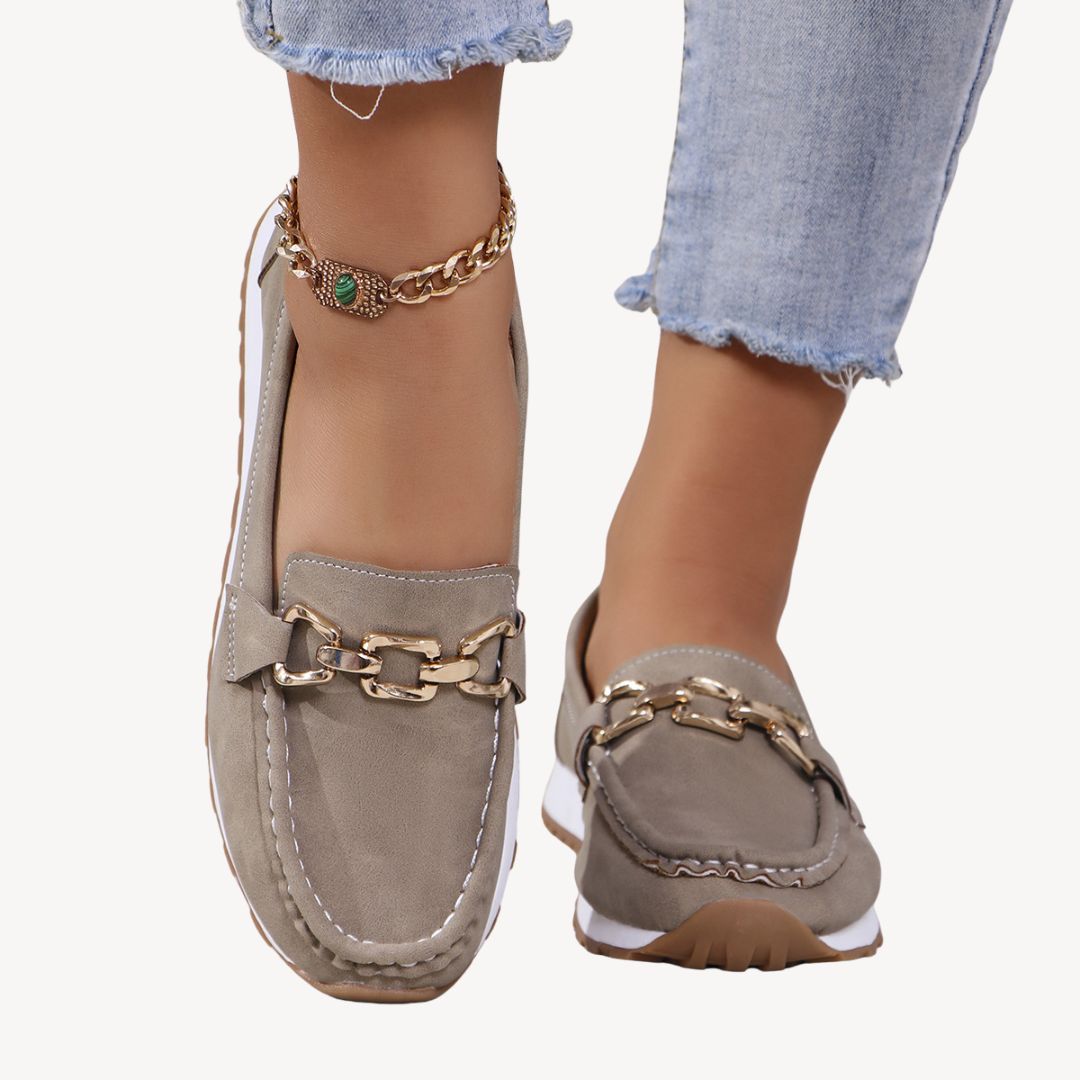 Modern women's orthopedic slip-on loafers with a chic chain, perfect for casual elegance & comfort.