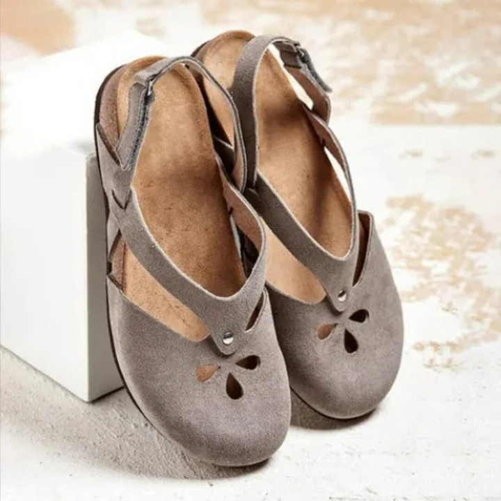Women's orthopedic slingback footwear, featuring a cross-strap design for a secure, comfortable fit.