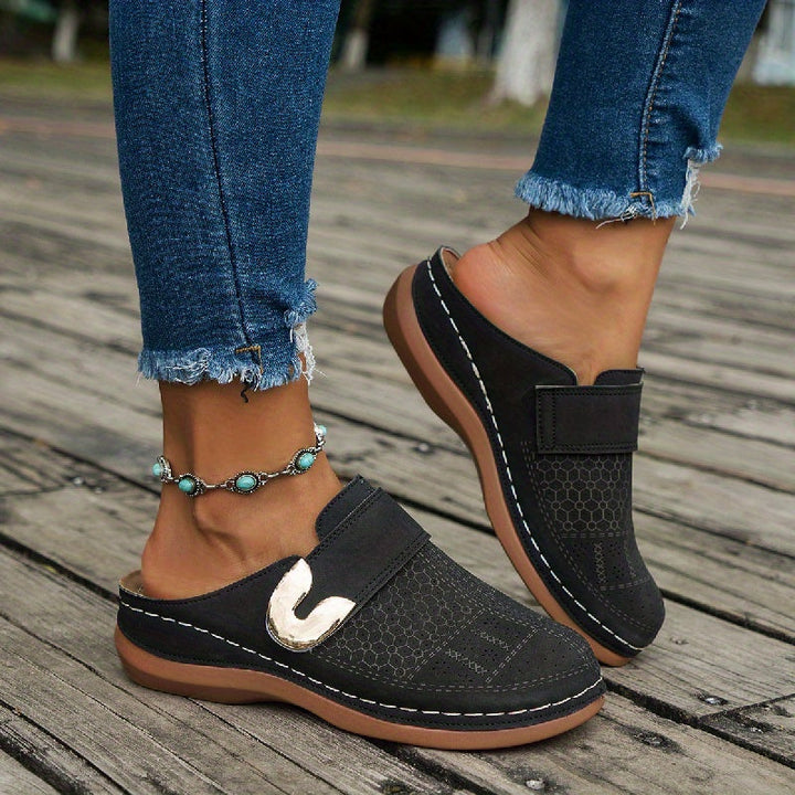 Women's arch support orthopedic slippers, providing comfort & stability with a non-slip sole for indoor use.