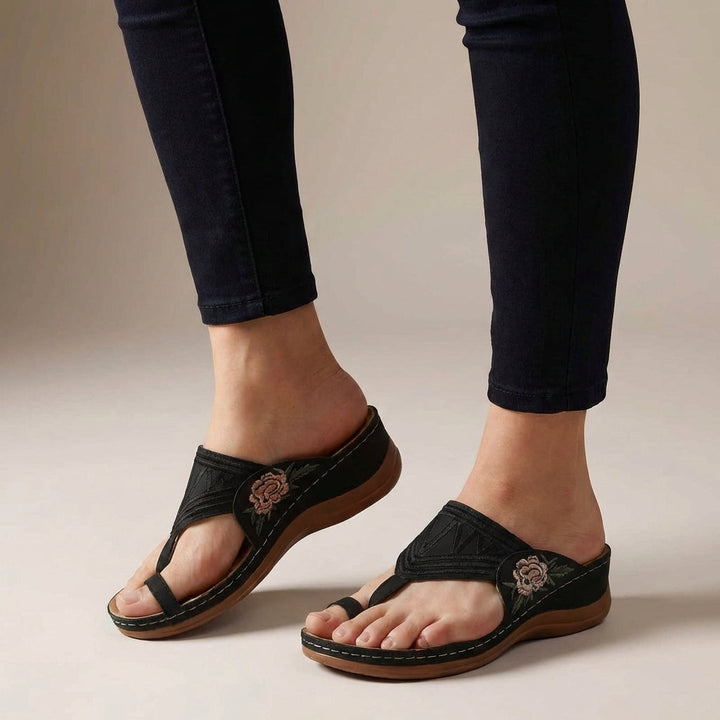 Supportive women's T-strap wedge sandals with orthopedic comfort for all-day wear.