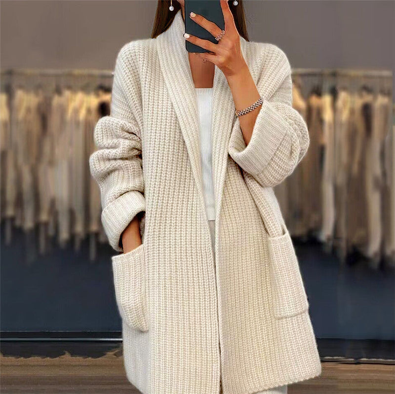 Women's oversized beige wool knit cardigan with spacious pockets, open front design for winter fashion.