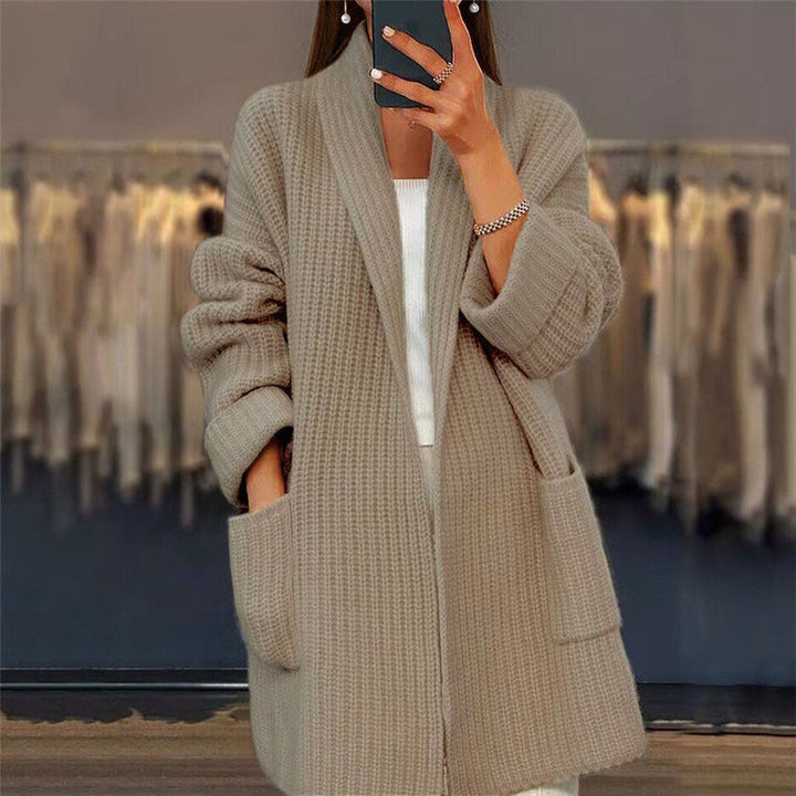 Beige oversized wool cardigan for women, a cozy knitwear piece with an open front and convenient pockets.