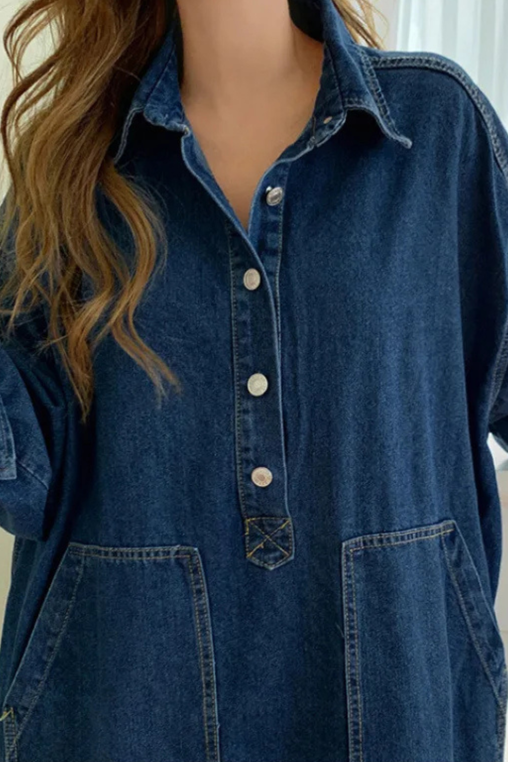 Blue denim oversized maxi dress for women. Collared, long sleeve, and includes useful pockets, ideal for casual outfits.