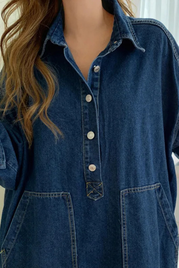 Blue denim oversized maxi dress for women. Collared, long sleeve, and includes useful pockets, ideal for casual outfits.