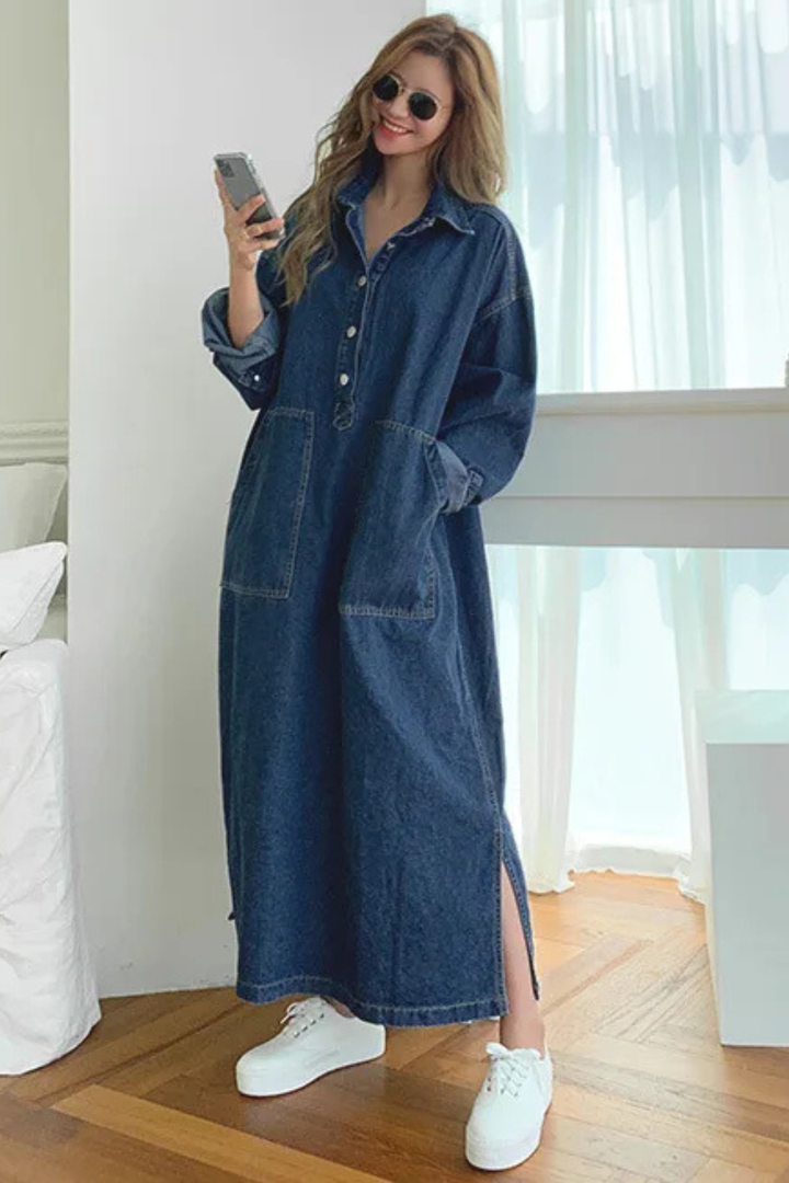 Casual women's oversized blue denim maxi dress. This comfortable, long sleeve, collared dress with pockets is perfect for everyday.