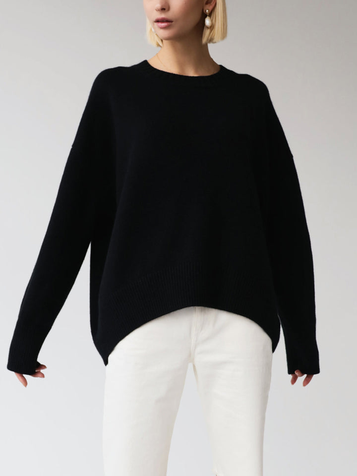 Women's oversized knit pullover sweater paired with jeans, casual winter outfit