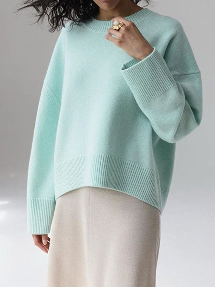 Woman posing in a women's oversized knit pullover sweater, relaxed and chic