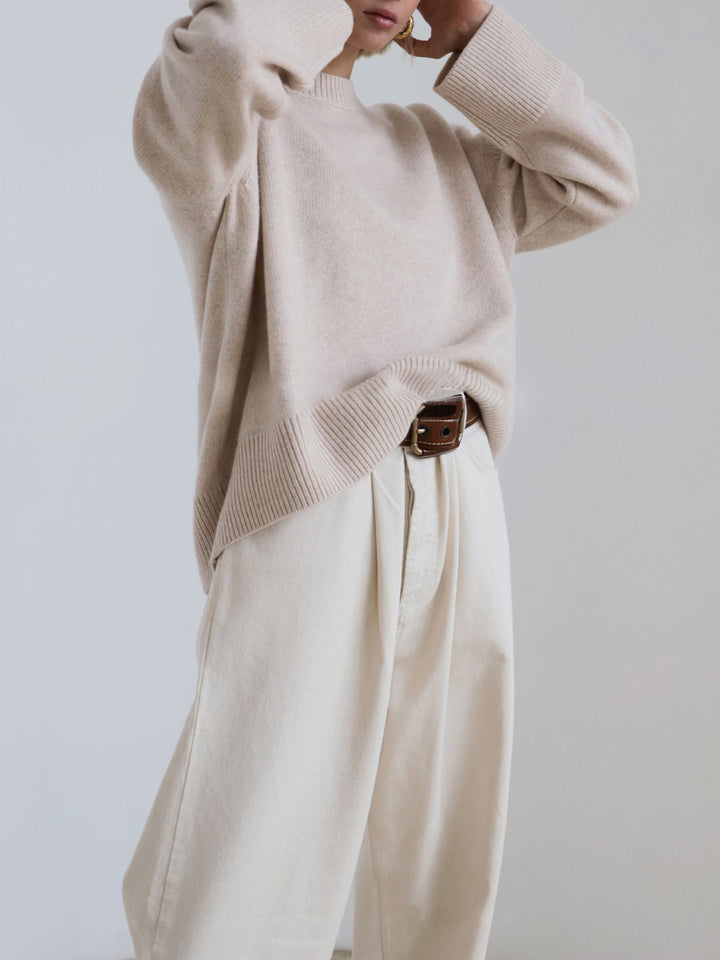 Back view of a women's knit pullover sweater, relaxed oversized style