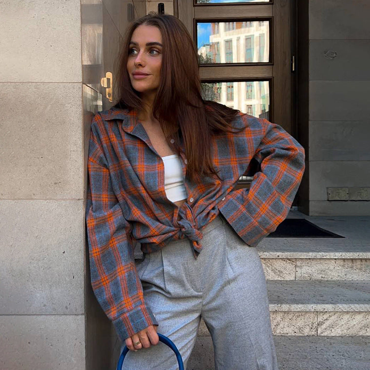 Stylish women's plaid oversized shirt. Comfortable long sleeve button-down blouse, perfect for casual fashion.
