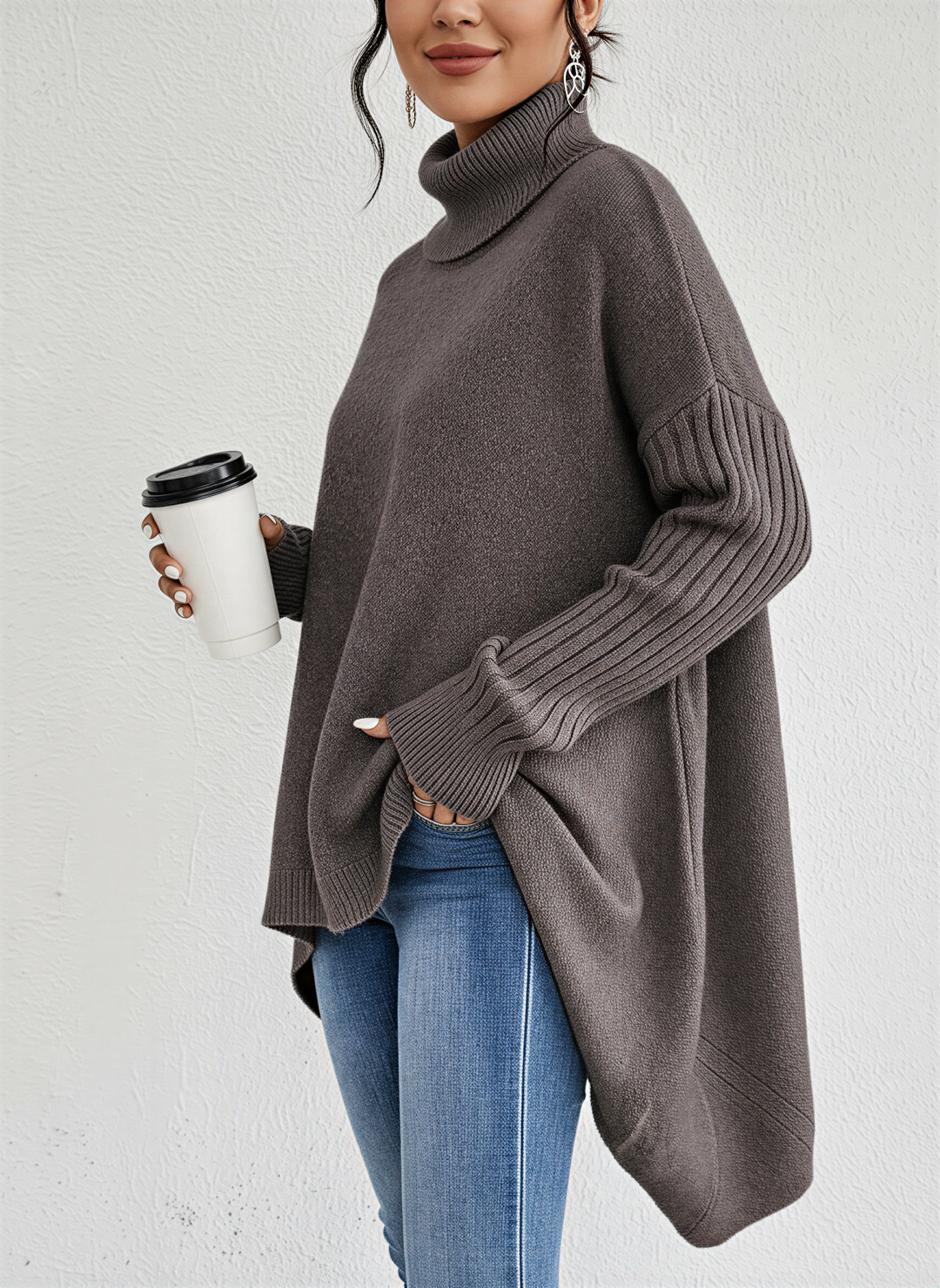 Soft women's oversized turtleneck sweater featuring a unique pocket design, great for relaxed outfits.