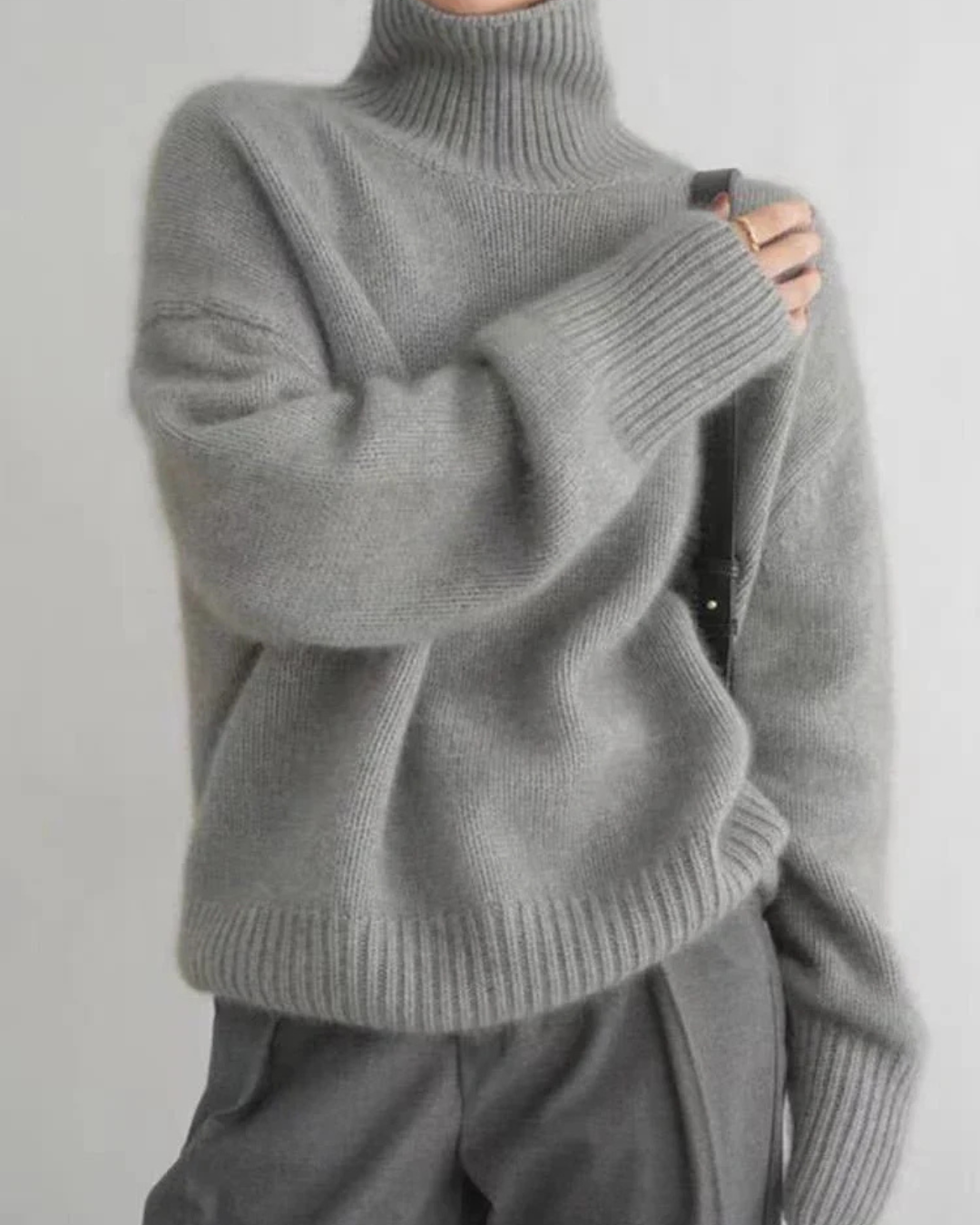 Stylish women's black oversized turtleneck knit sweater for a relaxed everyday look