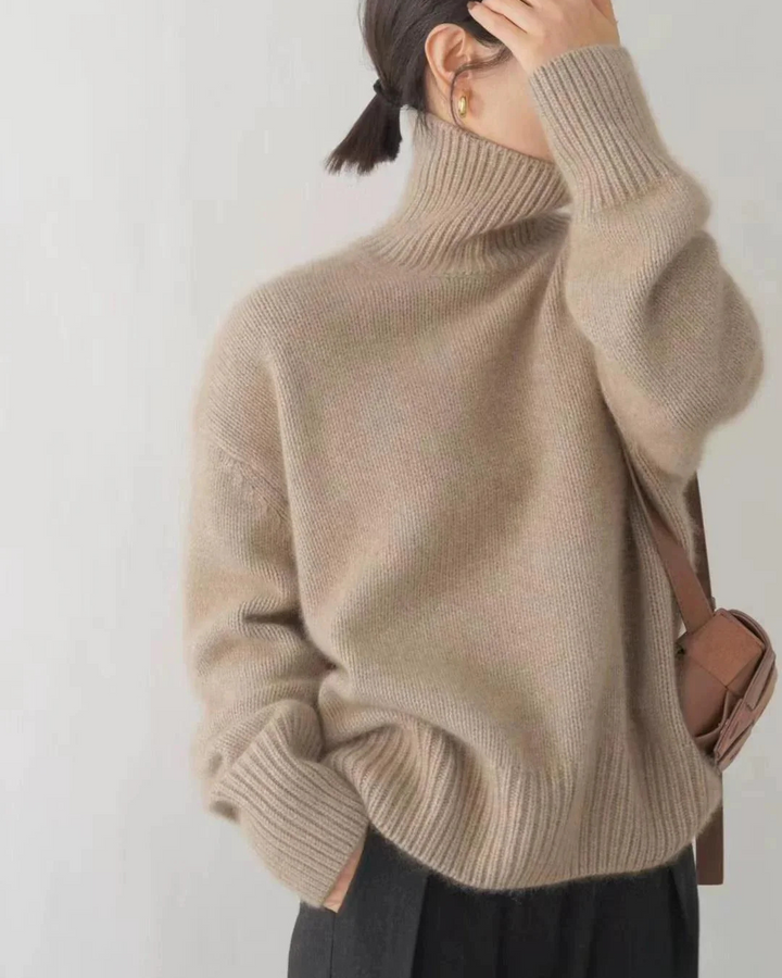 Close-up of the soft knitted texture of a women's casual oversized turtleneck sweater