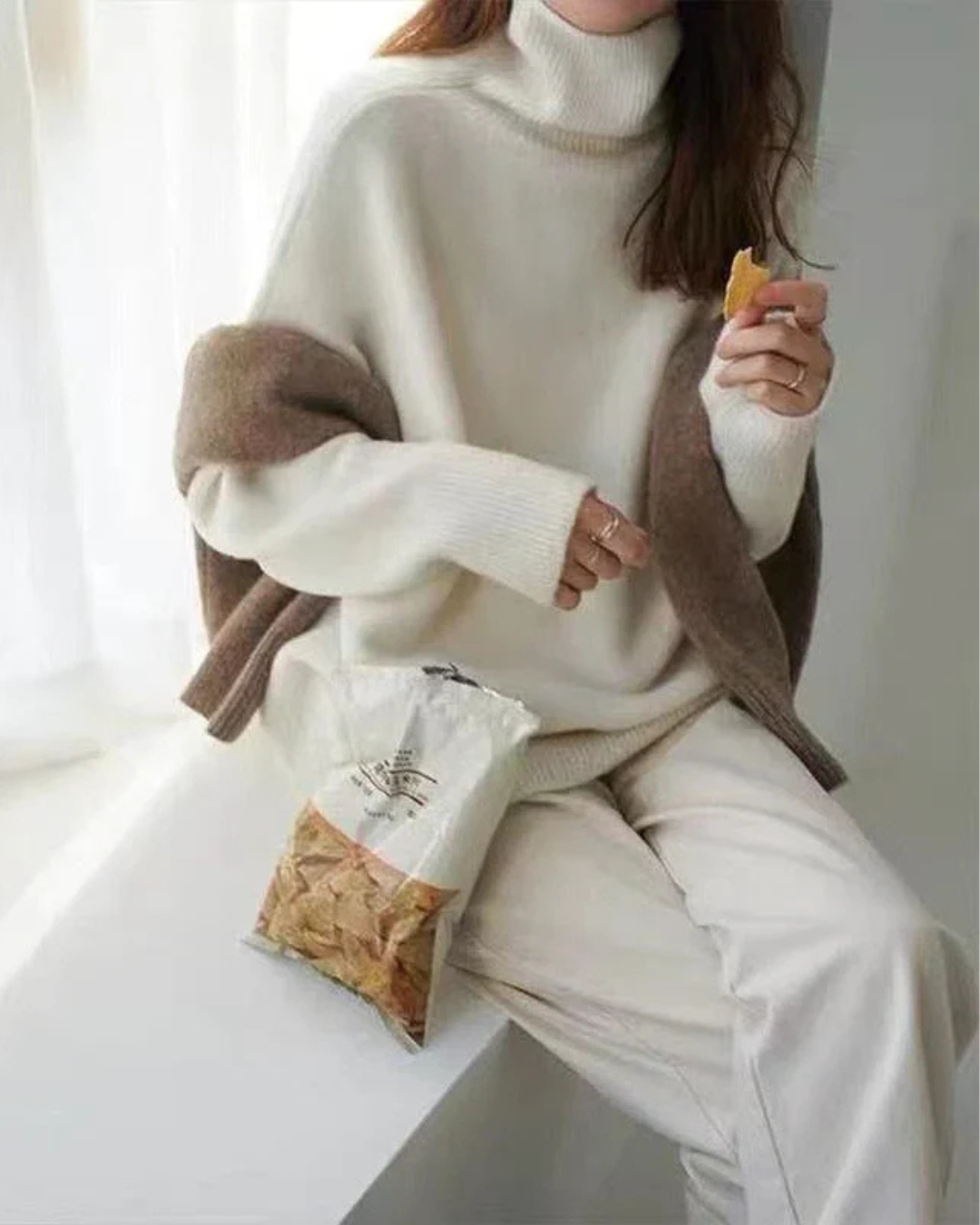 Women's elegant beige oversized turtleneck sweater, versatile for casual and chic styles